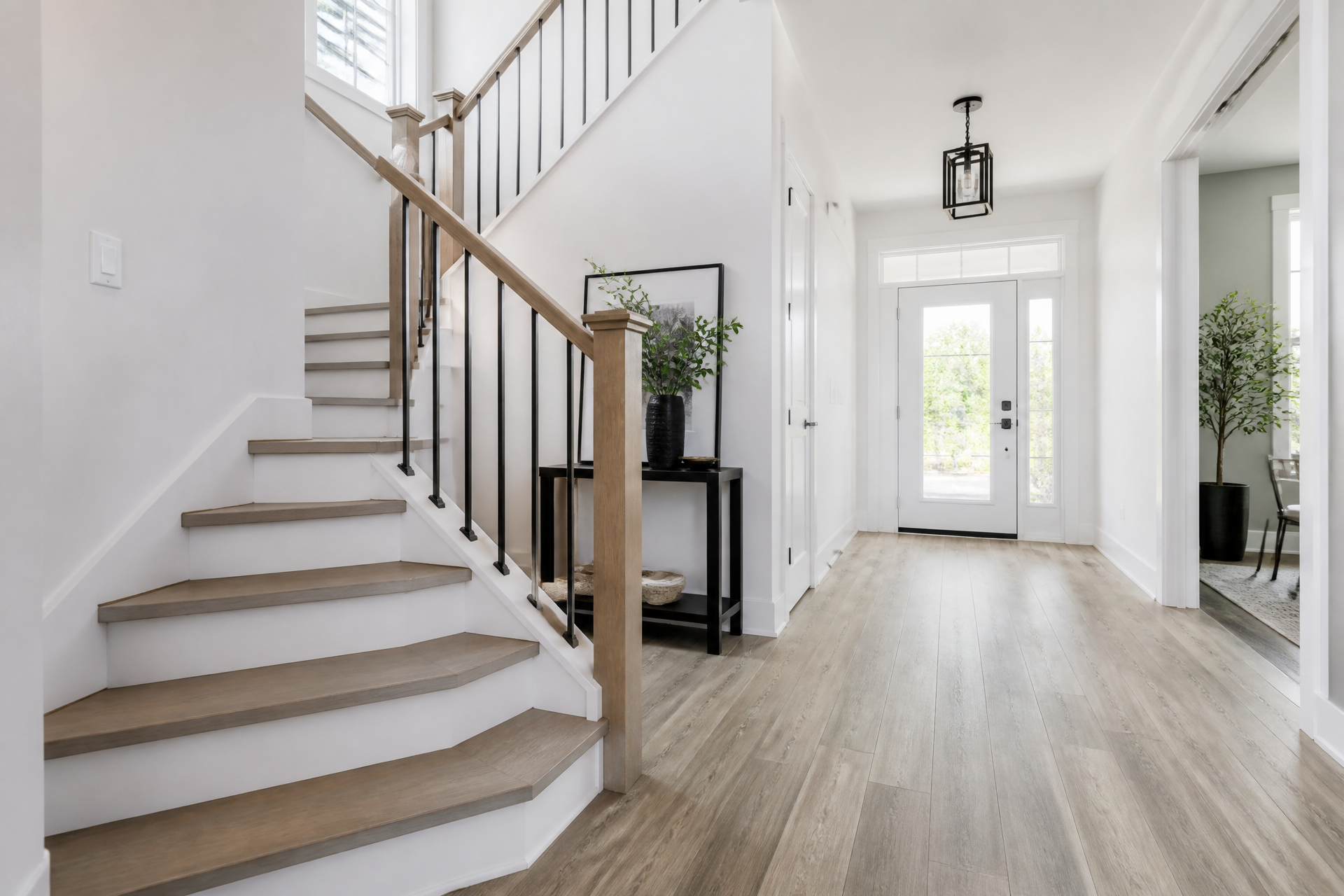 Bright entry hall and staircase with light wide-plank luxury vinyl flooring installed by The LVP Pros Flooring